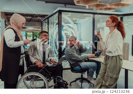 Young group of business people brainstorming together in a startup space, discussing business projects, investments, and solving challenges. 124213236
