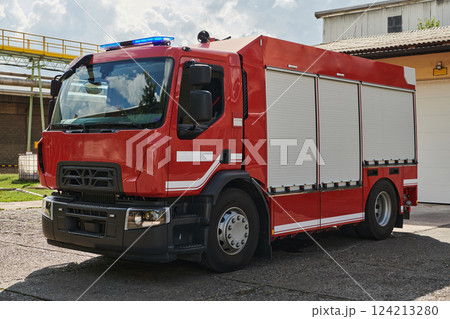 A state-of-the-art firetruck, equipped with advanced rescue technology, stands ready with its skilled firefighting team, prepared to intervene and respond rapidly to emergencies, ensuring the safety 124213280