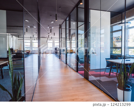In a setting of modern, glass-walled business startup offices, the open, airy workspace reflects a contemporary and innovative ambiance, promising a dynamic environment for entrepreneurial growth 124213299