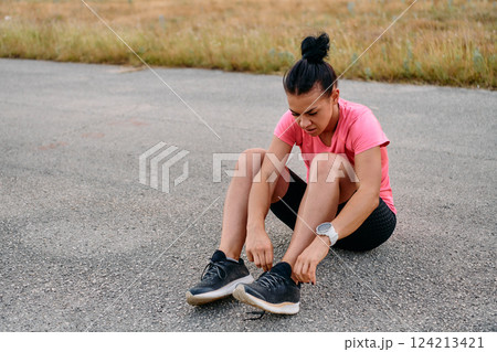 Athletic Woman Preparing for Morning Run 124213421