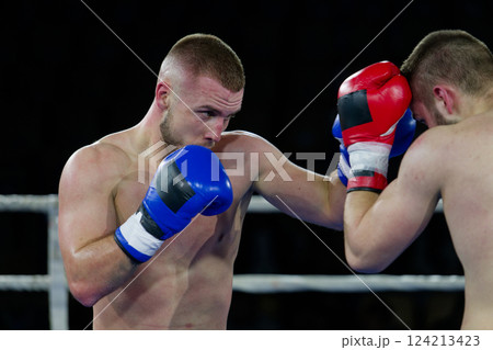 Fierce boxing match showcases athletes' power and skill. 124213423
