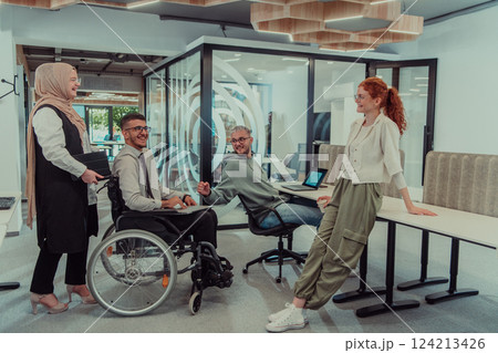Young group of business people brainstorming together in a startup space, discussing business projects, investments, and solving challenges. 124213426
