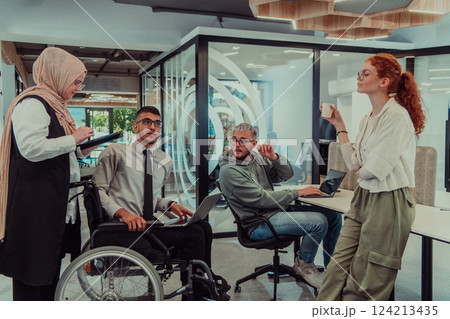 Young group of business people brainstorming together in a startup space, discussing business projects, investments, and solving challenges. Young group of business people brainstorming together in a startup space, discussing business projects, investments, and solving challenges. 124213435