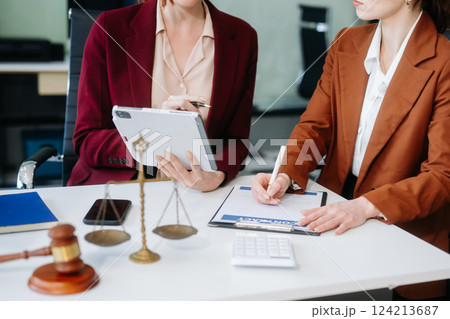 business people and lawyers discussing contract papers sitting at the table. Concepts of law, advice, legal services. 124213687