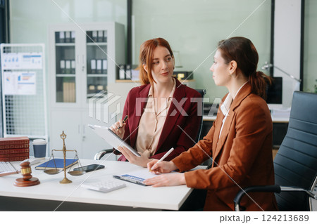 Professional female lawyers consulting on legal cases in a modern office. Perfect for law, business, justice 124213689