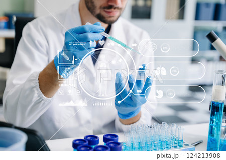 scientists conducting research investigations in a medical laboratory, a researcher in the foreground scientists conducting research investigations in a medical laboratory, a researcher in the foreground 124213908