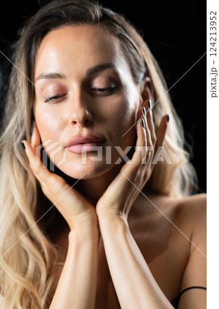 Radiant Elegance: A Stunning Blonde in a Black Dress Exuding Confidence and Beauty. Radiant Elegance: A Stunning Blonde in a Black Dress Exuding Confidence and Beauty. 124213952