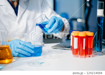 scientist researcher conducting an experiment working in the chemical laboratory 124214084