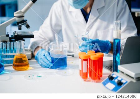 scientist researcher conducting an experiment working in the chemical laboratory 124214086