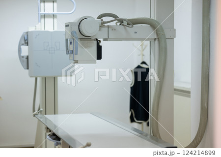 Modern X-ray machine in a medical examination room. 124214899