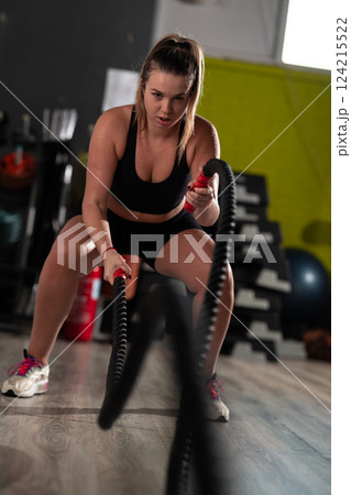 Fit Woman Performing Rope Conditioning Exercise in the Gym Fit Woman Performing Rope Conditioning Exercise in the Gym 124215522