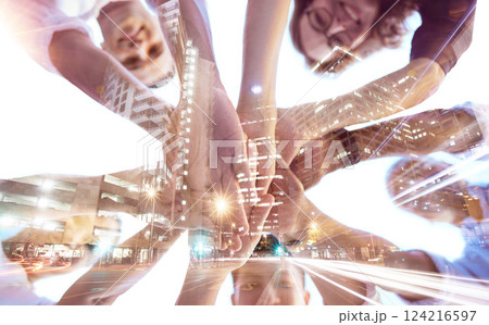 Hands, collaboration and city with digital overlay and business team in a huddle circle for support or trust. Teamwork, future and motivation with a man and woman employee group joined in partnership 124216597