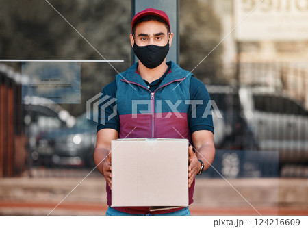 Delivery man, box and covid face mask working for courier service with package, shipment or parcel outdoor. Express, logistics and portrait of guy ready to deliver ecommerce order during coronavirus 124216609