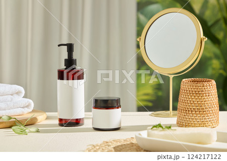 Tall plastic bottles and jars without labels, for design. Round table mirrors made of shiny gold metal. Brown rattan baskets, stacked towels placed on round wooden trays. Bottle mockup for cosmetics. Tall plastic bottles and jars without labels, for design. Round table mirrors made of shiny gold metal. Brown rattan baskets, stacked towels placed on round wooden trays. Bottle mockup for cosmetics. 124217122