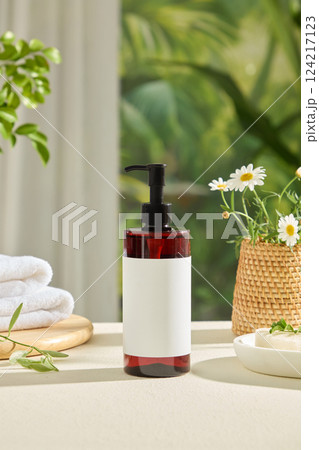 Frontal shot of tall plastic cosmetic bottle with pump, no label. Wicker vase with white flowers blooming Stacked towels on a wooden tray. Green background with many branches around. Advertising photo Frontal shot of tall plastic cosmetic bottle with pump, no label. Wicker vase with white flowers blooming Stacked towels on a wooden tray. Green background with many branches around. Advertising photo 124217123