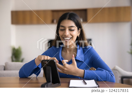 Woman make speech, record video, looking at smartphone screen Woman make speech, record video, looking at smartphone screen 124217831