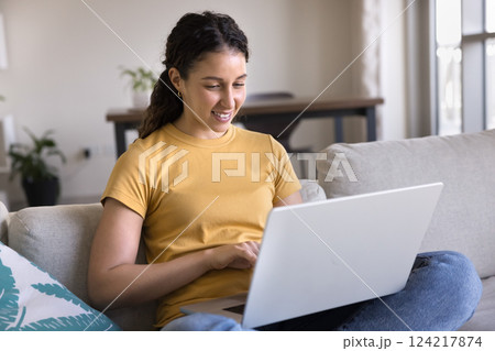 Latin woman spend weekend time on internet using laptop 124217874