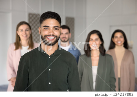Arabian man posing confidently in foreground, exuding satisfaction and pride 124217892