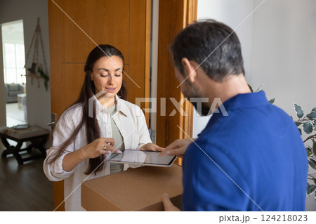 Customer woman receiving parcel from delivery service man Customer woman receiving parcel from delivery service man 124218023