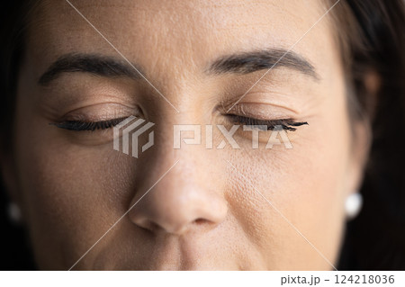 Closed eyes of young Latin woman with permanent eyelashes Closed eyes of young Latin woman with permanent eyelashes 124218036