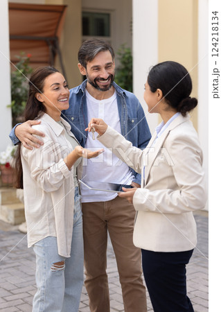 Happy Latin family couple getting new home, taking key Happy Latin family couple getting new home, taking key 124218134