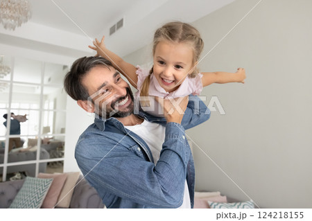 Cheerful father enjoying playtime with playful little girl Cheerful father enjoying playtime with playful little girl 124218155