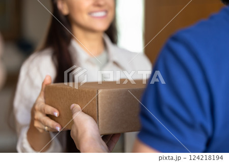 Female customer taking parcel from delivery logistic service worker man 124218194