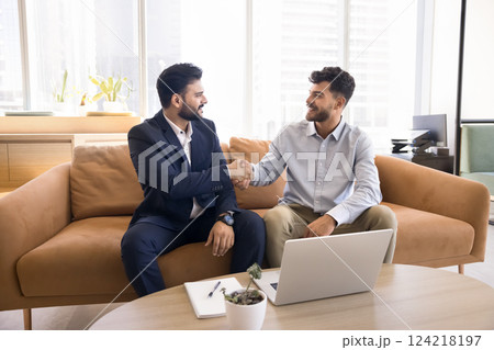 Two young 30s businessmen shaking hands, finish successful business meeting Two young 30s businessmen shaking hands, finish successful business meeting 124218197