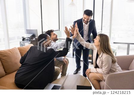 Four multinational teammates giving high five gesture of unity 124218215