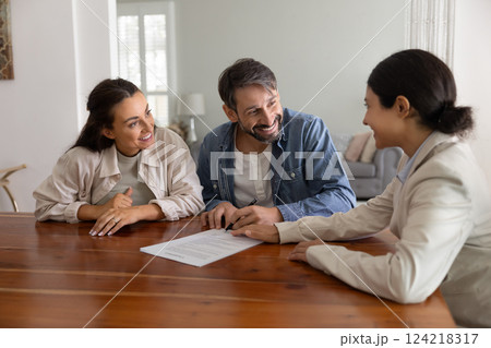 Happy husband and wife meeting with realtor, financial broker Happy husband and wife meeting with realtor, financial broker 124218317