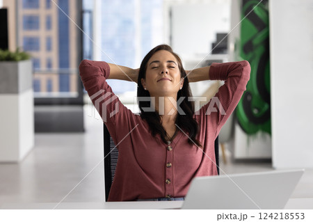 Peaceful manager woman breathing fresh air at work table Peaceful manager woman breathing fresh air at work table 124218553