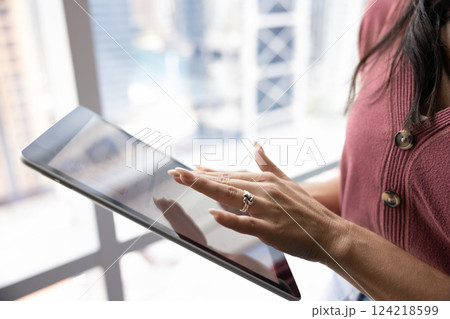 Cropped shot of business woman using application on tablet computer 124218599