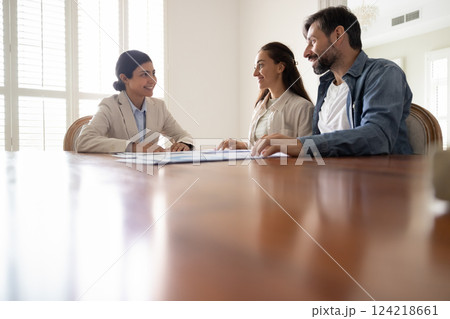 Couple of customers and financial consultant discussing mortgage Couple of customers and financial consultant discussing mortgage 124218661