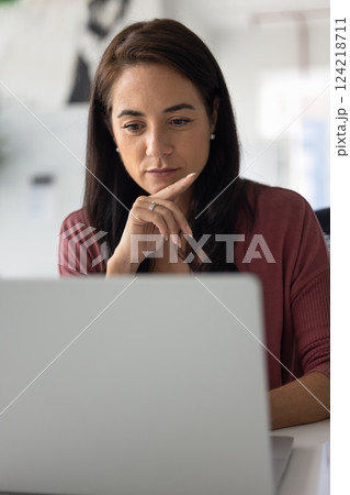 Focused pensive business woman working at laptop 124218711