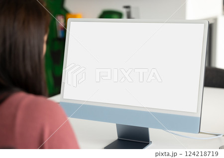 White blank screen of monitor on workplace table of employee 124218719