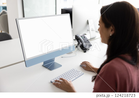 Female office employee using desktop monitor with blank copy space Female office employee using desktop monitor with blank copy space 124218723