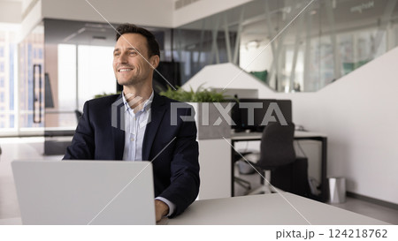Ambitious business leader man working at laptop in modern office Ambitious business leader man working at laptop in modern office 124218762