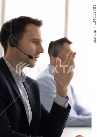 Focused Latin telemarketing professional man speaking to customer on phone Focused Latin telemarketing professional man speaking to customer on phone 124218781