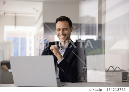 Happy business executive man working at computer at office workplace 124218783