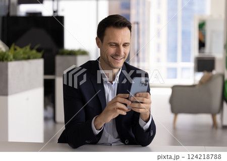 Positive confident Hispanic businessman using financial trading application Positive confident Hispanic businessman using financial trading application 124218788