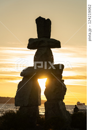 Inukshuk stone sculpture in the sunset time at English Bay Beach, Vancouver City beautiful landscape. British Columbia, Canada. 124219062
