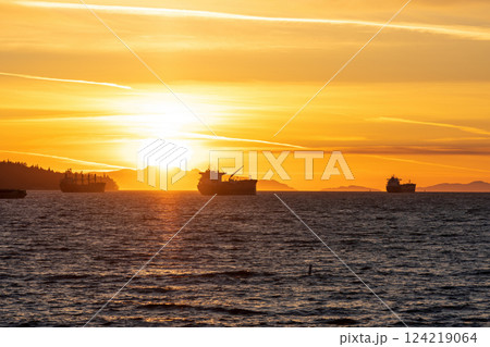 Sunset time at English Bay Beach and ships parked on the ocean. Vancouver City beautiful landscape. British Columbia, Canada. 124219064