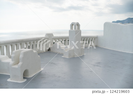 A blue door with a lock sits in front of a white building. The door is the only visible part of the building, and it is blue in color. 124219603