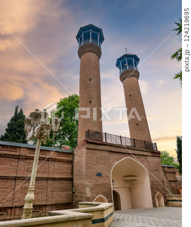 Juma Mosque of Ganja, Azerbaijan, with its two tall minarets and red bricks facade 124219695