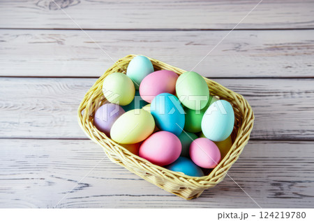 Hand Painted Pastel Easter Eggs In Wicker Basket Close Up View Of Colorful Eggs On Simple Green Wooden Surface, Showcasing Easters Delight 124219780