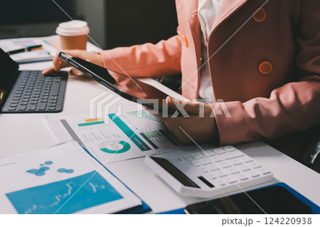 Cropped image of professional businesswoman working at her office via laptop, young female manager using portable computer device while sitting at modern loft, flare light, work process concept Cropped image of professional businesswoman working at her office via laptop, young female manager using portable computer device while sitting at modern loft, flare light, work process concept 124220938