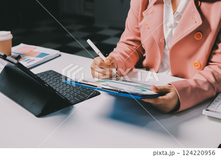 Cropped image of professional businesswoman working at her office via laptop, young female manager using portable computer device while sitting at modern loft, flare light, work process concept Cropped image of professional businesswoman working at her office via laptop, young female manager using portable computer device while sitting at modern loft, flare light, work process concept 124220956