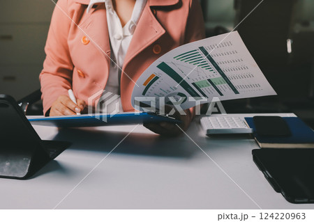 Cropped image of professional businesswoman working at her office via laptop, young female manager using portable computer device while sitting at modern loft, flare light, work process concept Cropped image of professional businesswoman working at her office via laptop, young female manager using portable computer device while sitting at modern loft, flare light, work process concept 124220963