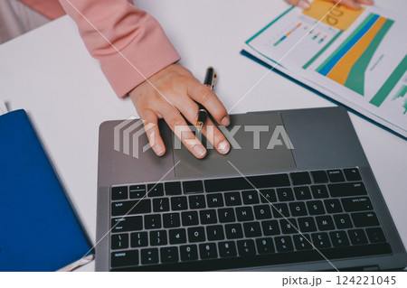 Cropped image of professional businesswoman working at her office via laptop, young female manager using portable computer device while sitting at modern loft, flare light, work process concept Cropped image of professional businesswoman working at her office via laptop, young female manager using portable computer device while sitting at modern loft, flare light, work process concept 124221045