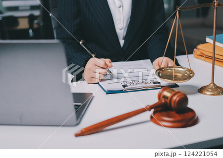 Judge gavel with Justice lawyers having team meeting at law firm background. Concepts of Law and Legal services. 124221054
